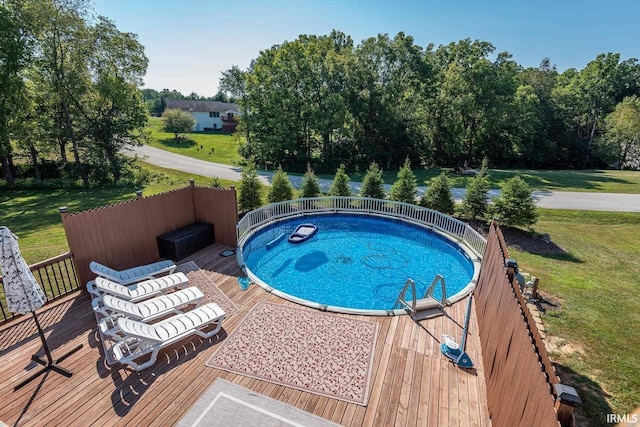 view of swimming pool featuring a yard, a jacuzzi, and a deck