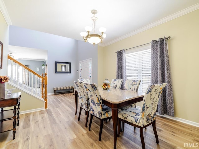 dining space with baseboards, a chandelier, stairs, light wood-type flooring, and ornamental molding