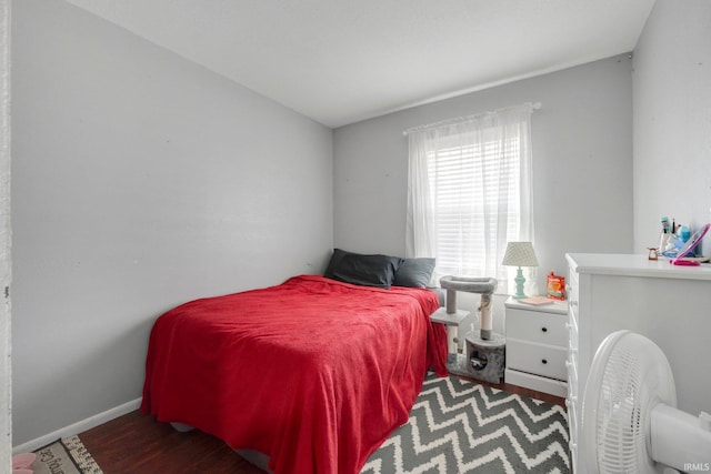 bedroom with baseboards and wood finished floors