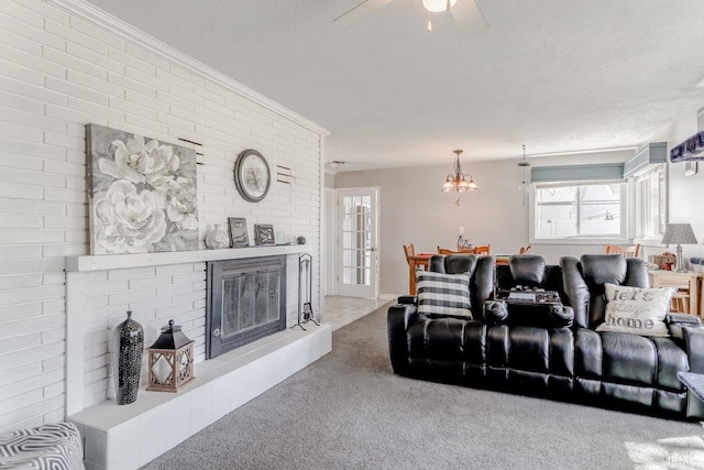 carpeted living area with a fireplace, a textured ceiling, crown molding, and a ceiling fan