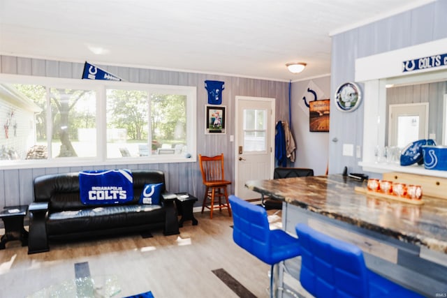 interior space featuring wood finished floors and ornamental molding