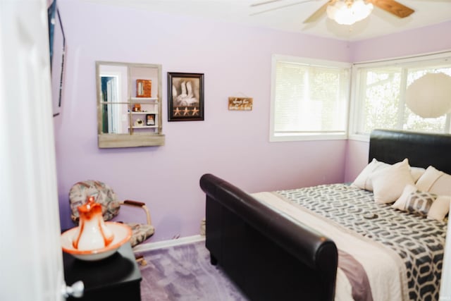 bedroom featuring wood finished floors, baseboards, and ceiling fan