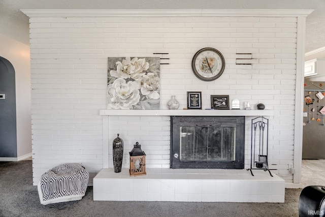 interior details featuring carpet flooring, a fireplace, and ornamental molding