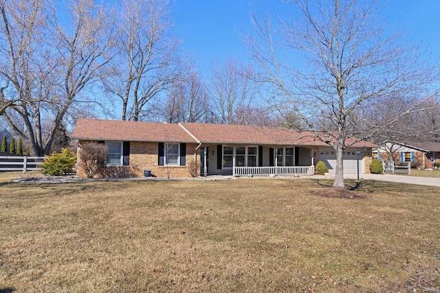 single story home with a porch, an attached garage, a front lawn, and fence