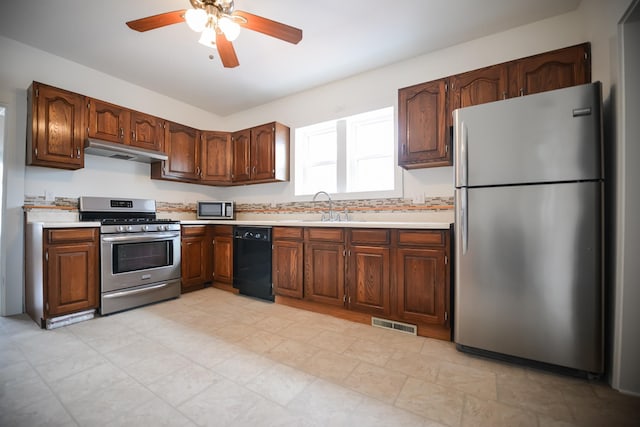 kitchen with visible vents, under cabinet range hood, a sink, stainless steel appliances, and light countertops