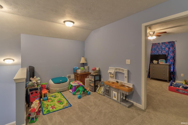 rec room featuring vaulted ceiling, carpet flooring, baseboards, and a textured ceiling