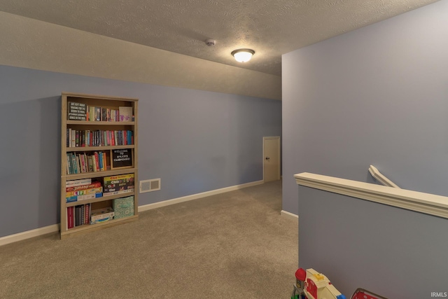 playroom with lofted ceiling, carpet, visible vents, and baseboards