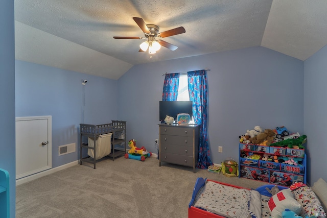 carpeted bedroom with visible vents, baseboards, vaulted ceiling, a textured ceiling, and a ceiling fan