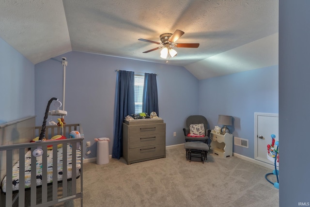 bedroom featuring visible vents, a textured ceiling, carpet, and lofted ceiling