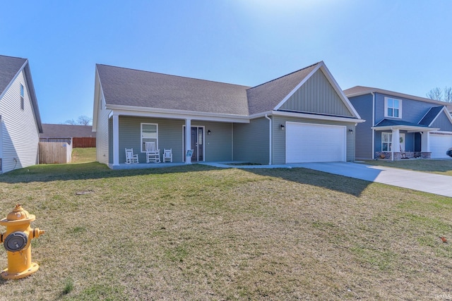 view of front of house with driveway, fence, board and batten siding, a front yard, and a garage