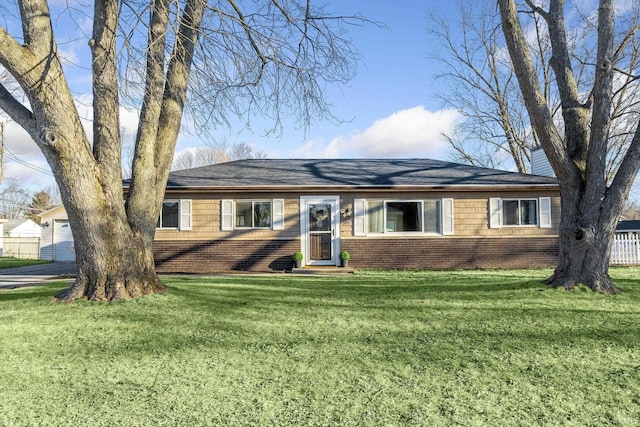 ranch-style home with brick siding, a garage, a front yard, and fence