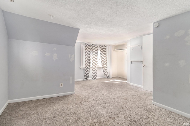 unfurnished room with baseboards, carpet floors, and a textured ceiling