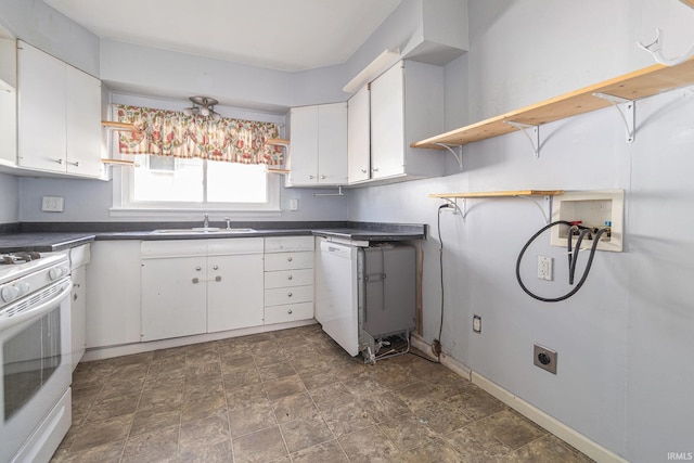 kitchen featuring white appliances, open shelves, a sink, white cabinetry, and dark countertops