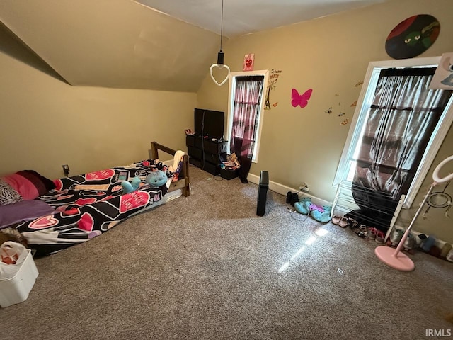 carpeted bedroom with baseboards and vaulted ceiling