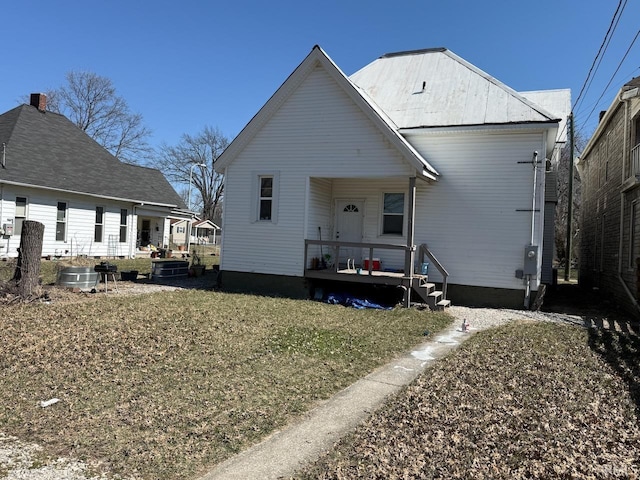 back of house with a lawn and a porch