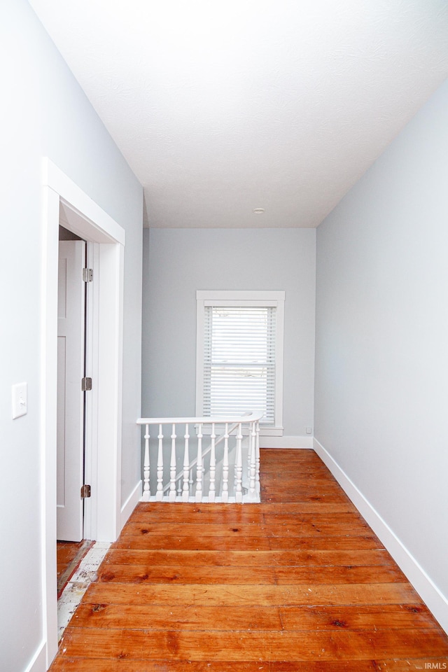 empty room featuring baseboards and wood finished floors