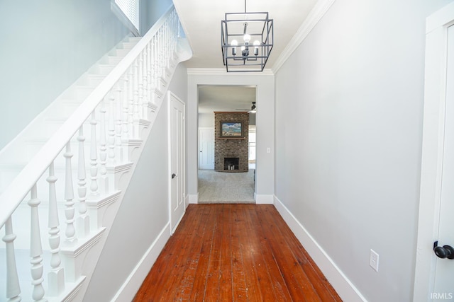 hall with baseboards, dark wood-style flooring, stairs, and crown molding