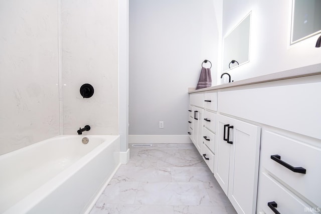 bathroom with marble finish floor, vanity, shower / bathing tub combination, and baseboards