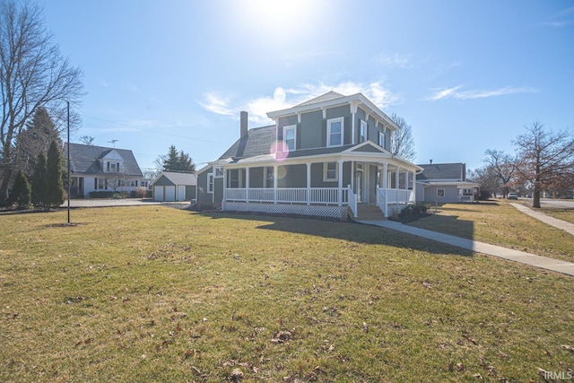 view of front facade with a garage, covered porch, an outdoor structure, and a front lawn