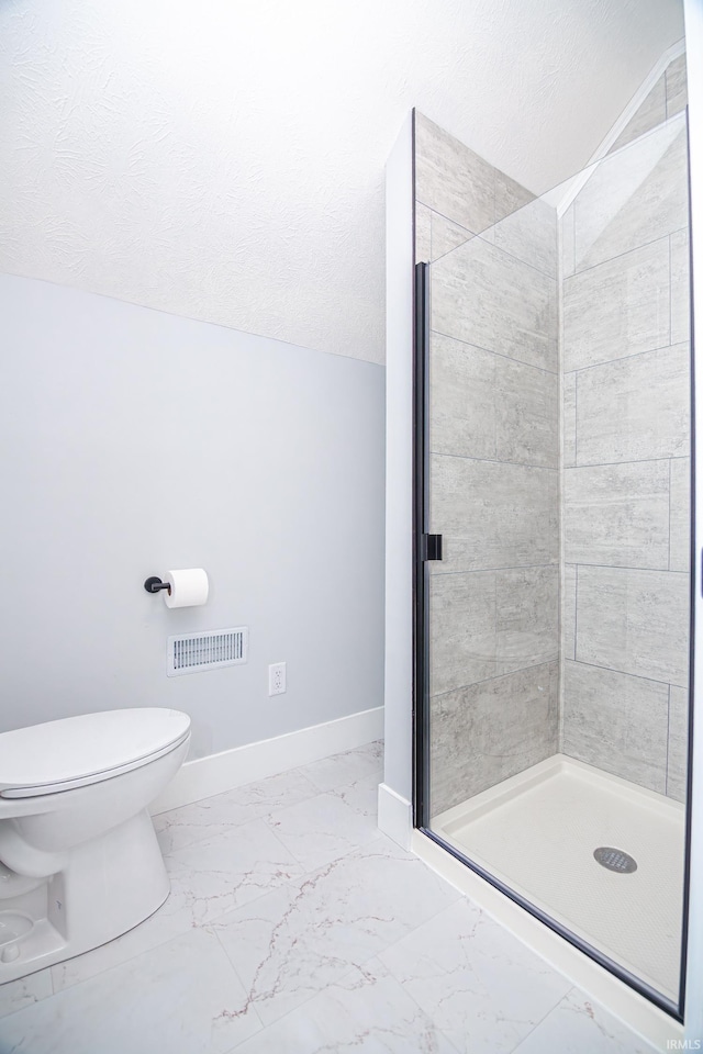 bathroom with visible vents, marble finish floor, a shower stall, and baseboards