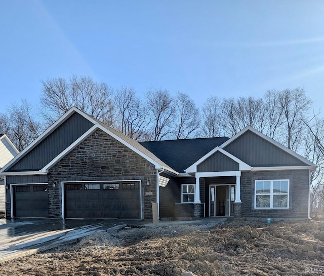 craftsman-style home featuring a garage and driveway