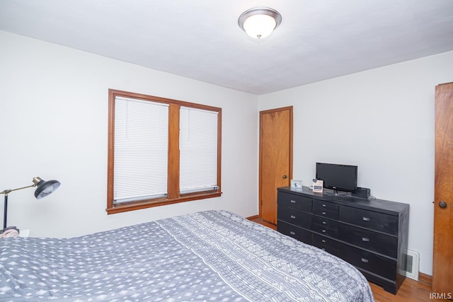 bedroom featuring light wood-type flooring and visible vents