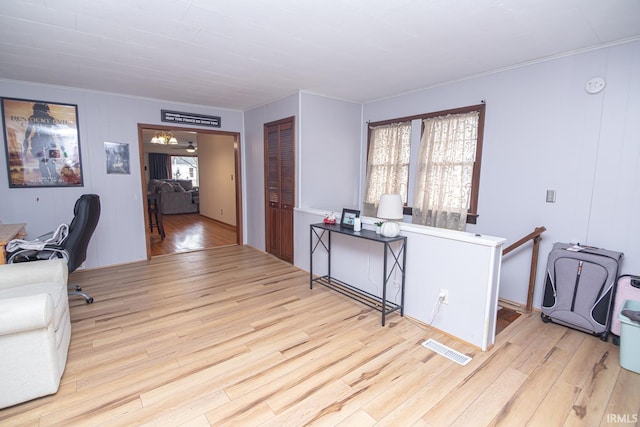 office area featuring visible vents, a healthy amount of sunlight, crown molding, and light wood-type flooring