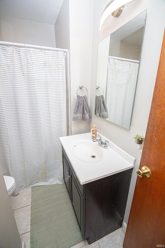 full bathroom featuring vanity, tile patterned floors, and toilet