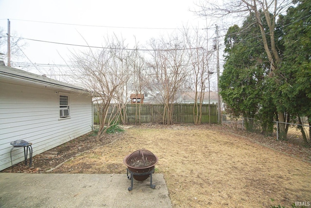 view of yard with a fire pit and a fenced backyard