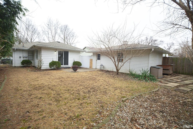 rear view of property featuring fence