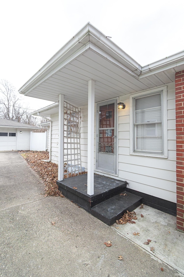 entrance to property with brick siding and covered porch