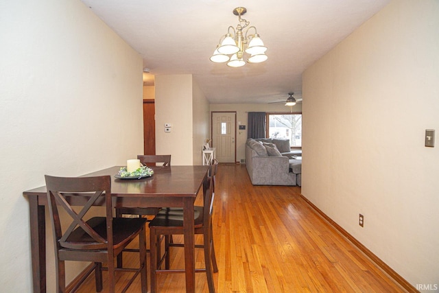 dining area featuring ceiling fan, light wood-type flooring, and baseboards