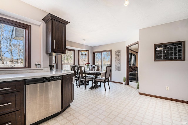 kitchen with light countertops, baseboards, light floors, dark brown cabinets, and dishwasher