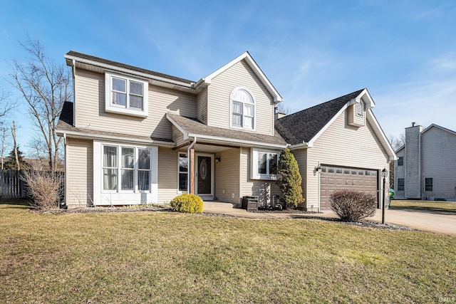 traditional-style house with a front yard, concrete driveway, a garage, and roof with shingles