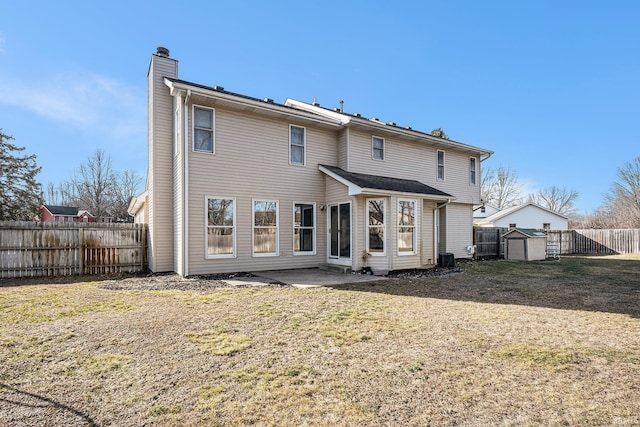 rear view of property with a patio, a fenced backyard, a yard, a storage shed, and an outdoor structure