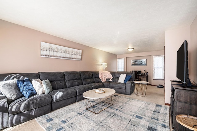 carpeted living area with baseboards