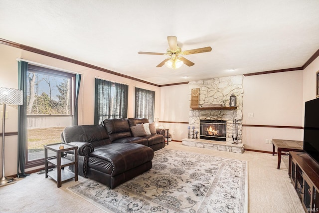 carpeted living area with a ceiling fan, crown molding, a fireplace, and baseboards