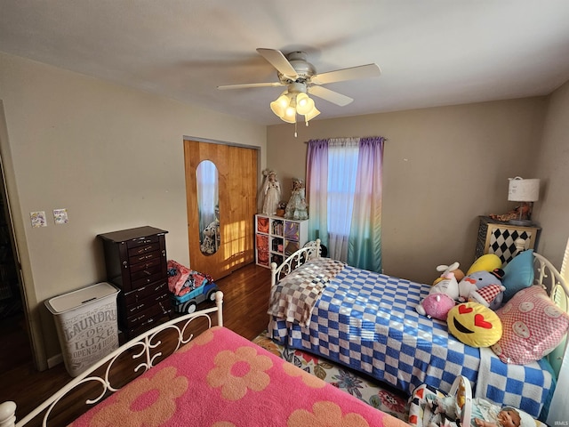 bedroom featuring a ceiling fan and wood finished floors