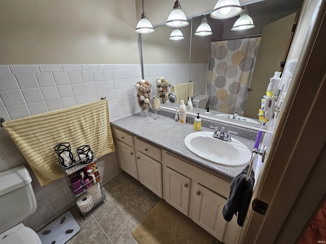 bathroom featuring a shower with curtain, toilet, tile walls, tile patterned flooring, and vanity