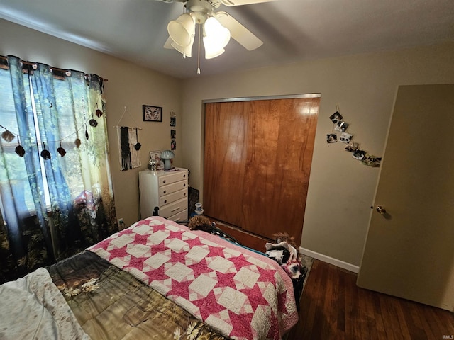 bedroom with a closet, baseboards, a ceiling fan, and wood finished floors