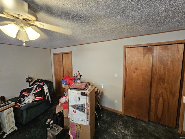 interior space with carpet flooring, a textured ceiling, and ceiling fan