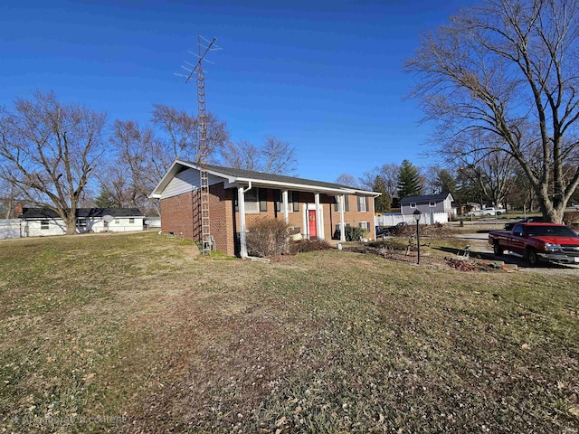 view of front of property with a front yard and brick siding