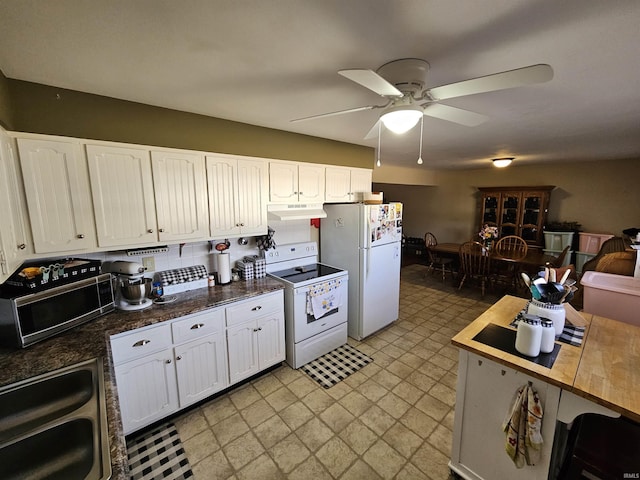 kitchen featuring ceiling fan, under cabinet range hood, white appliances, white cabinetry, and a sink