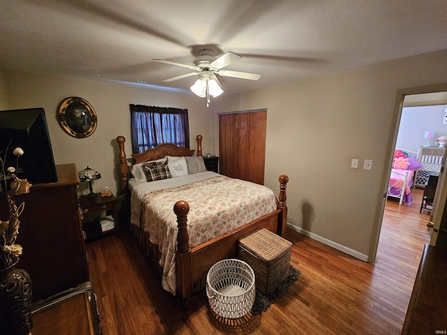 bedroom with wood finished floors, baseboards, and ceiling fan