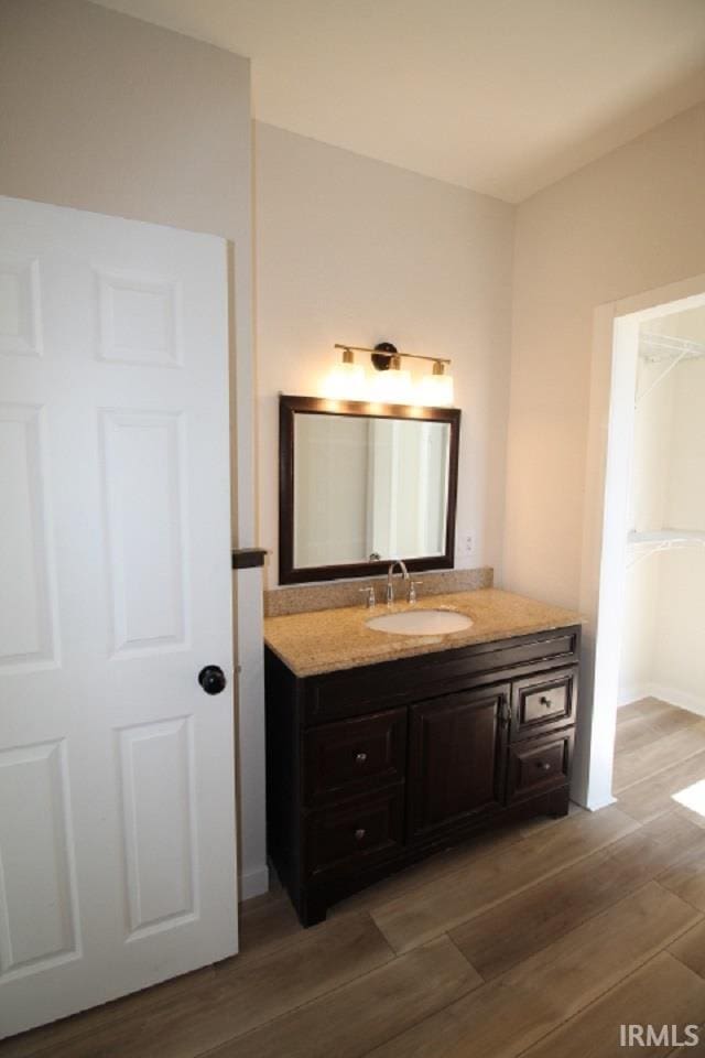 bathroom with vanity and wood finished floors