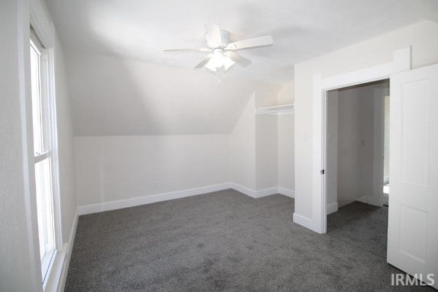 additional living space with baseboards, lofted ceiling, a ceiling fan, and carpet flooring