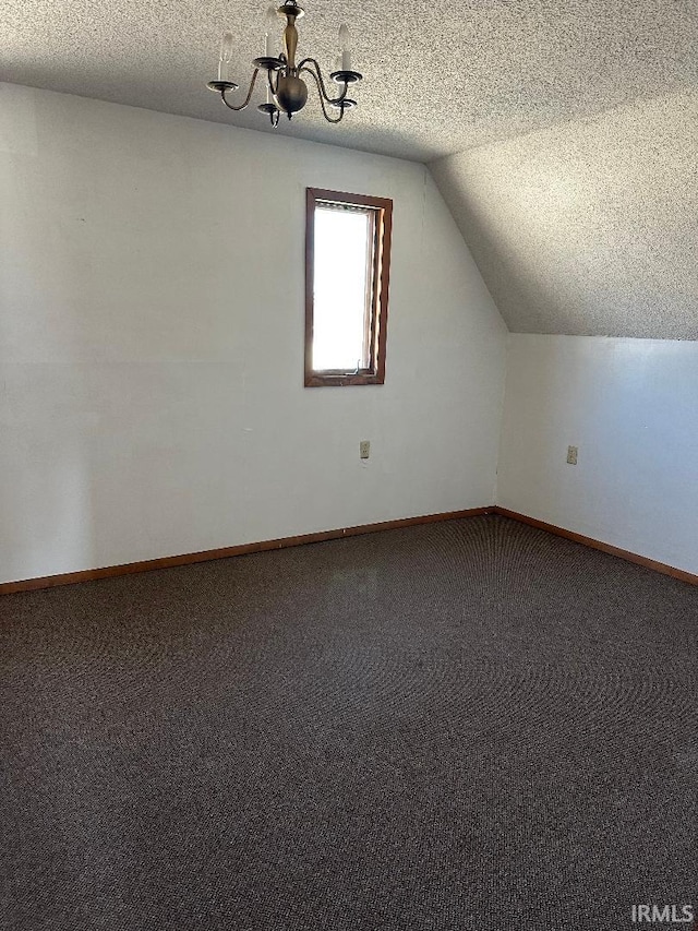 bonus room featuring vaulted ceiling, a textured ceiling, baseboards, and carpet floors