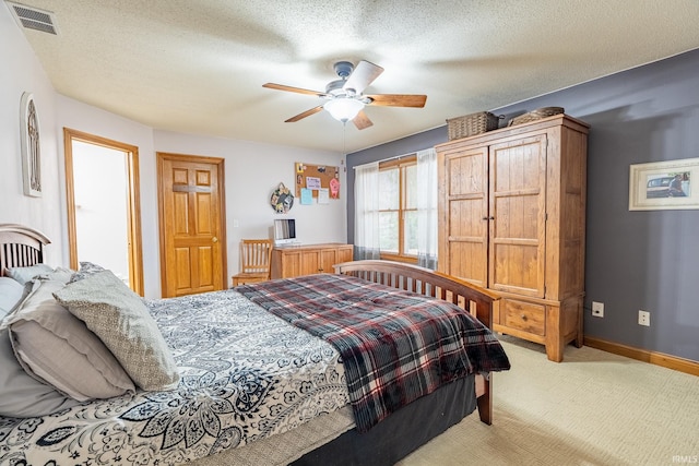 bedroom featuring visible vents, baseboards, carpet, and a textured ceiling