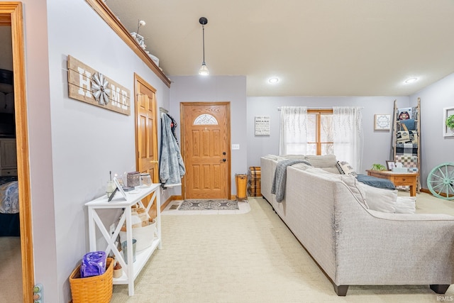 entryway with light carpet, recessed lighting, and baseboards