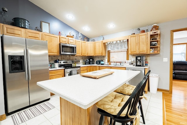 kitchen with decorative backsplash, stainless steel appliances, and light countertops